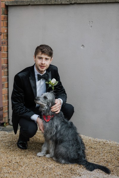 Groom ready posing with fluffy dog