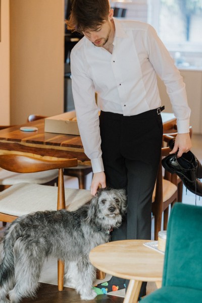 Dog and groom pose together