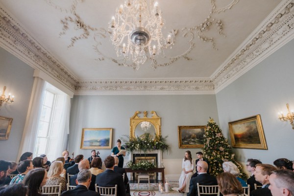 Wide shot of ceremony guests bride groom celebrant/officiant