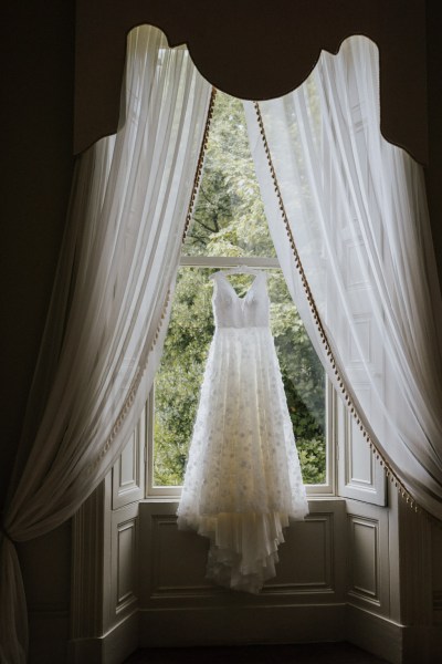 Bridal gown/dress hanging at window