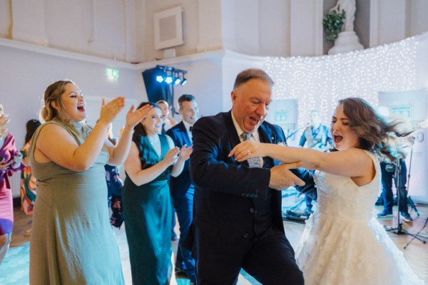 Family members bride and bridesmaids dance on the dancefloor