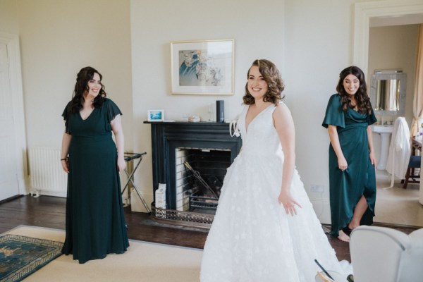 Bridesmaids and bride pose in room