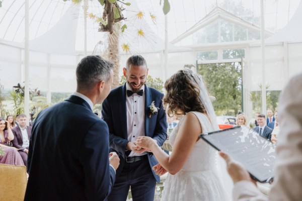 Bride groom and celebrant at top of alter