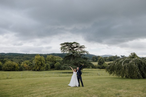 Bride and groom standing in the grass