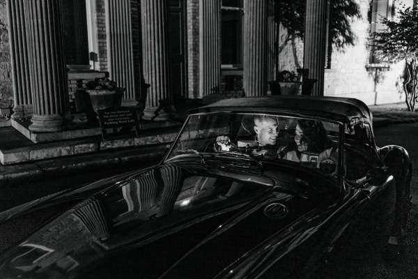 Black and white bride and groom interior inside wedding car