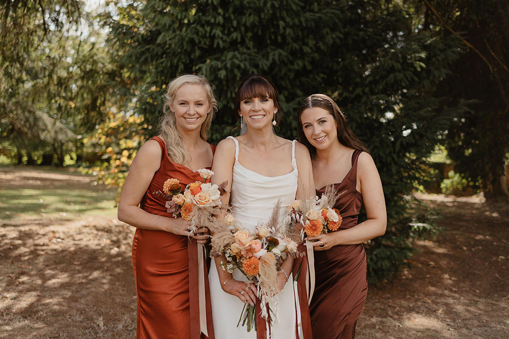 Bride and bridesmaids autumnal flowers bouquet roses