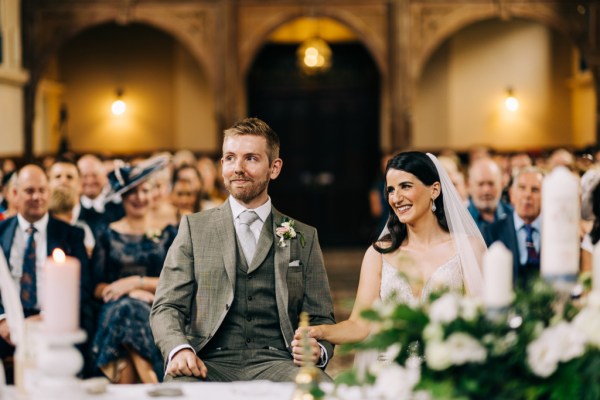 Bride and groom laugh at the alter