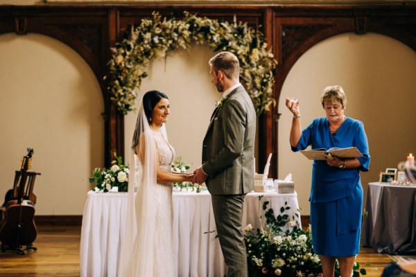 Celebrant bride and groom at alter to church