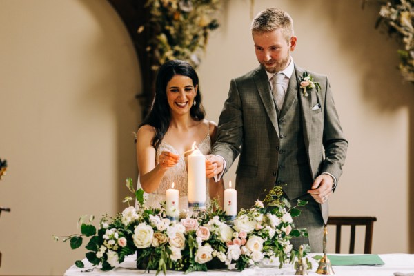 Bride and groom light the candle together