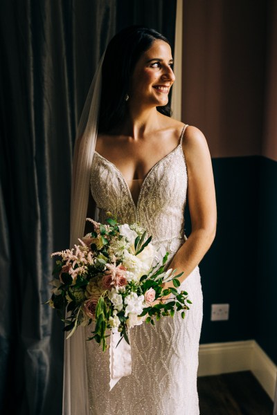 Bride poses for a picture as she's ready for wedding she looks down