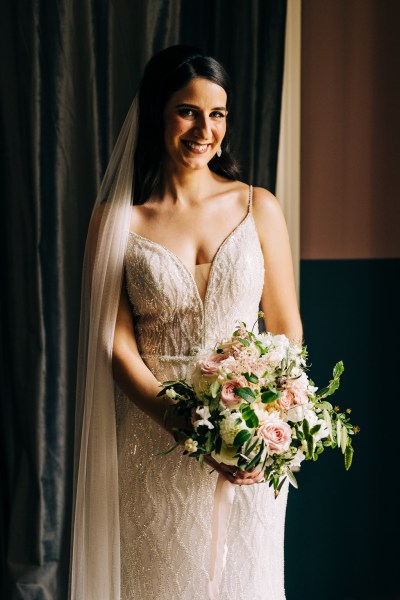 Bride poses for a picture as she's ready for wedding she looks down