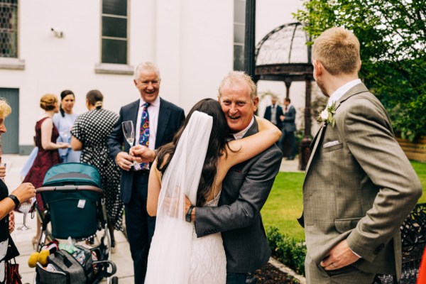 Bride hugs her father exterior shot