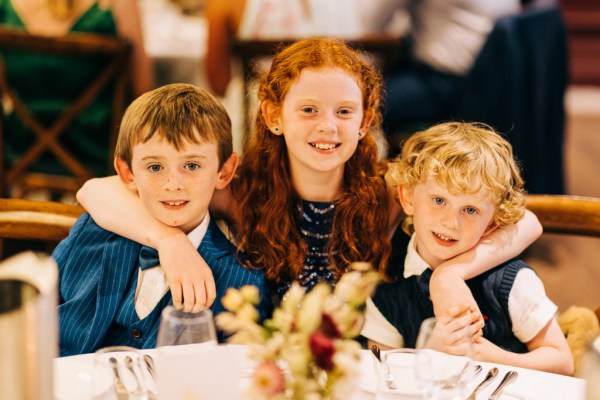 Red headed girl in middle of two little boys