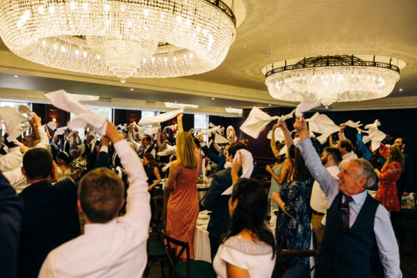 Guests clapping celebrating couple