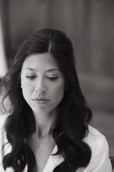 Black and white image of bride getting ready hair and makeup