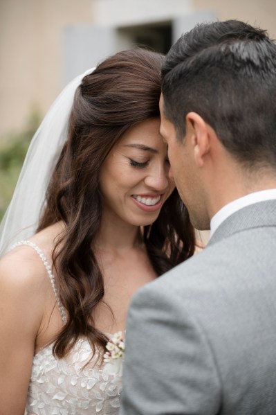 Bride and groom hold each other and laugh