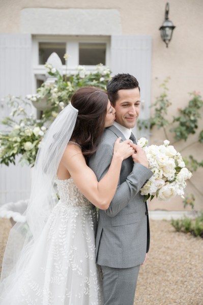 Kiss on the cheek from bride to groom