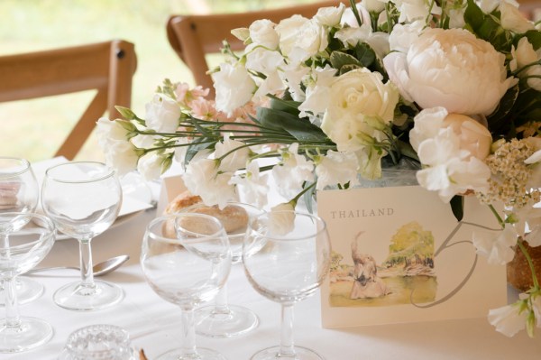 Flowers on the table dining room glasses candles lit roses cutlery