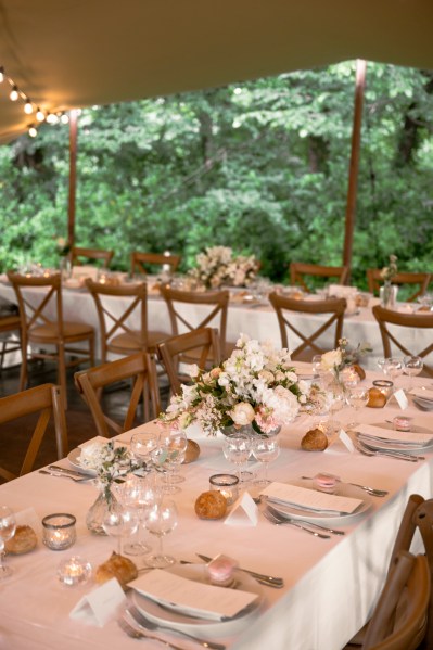 Flowers on the table dining room glasses candles lit roses cutlery