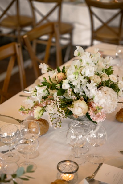 Flowers on the table dining room glasses candles lit roses cutlery