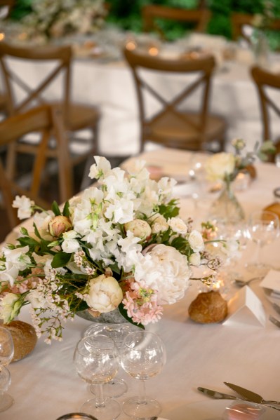 Flowers on the table dining room glasses candles lit roses cutlery