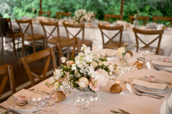 Flowers on the table dining room glasses candles lit roses cutlery