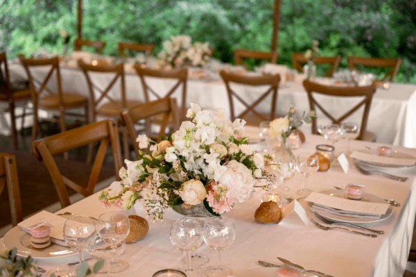 Flowers on the table dining room glasses candles lit roses cutlery