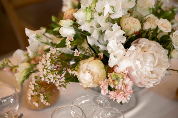 Flowers on the table dining room glasses candles lit roses cutlery