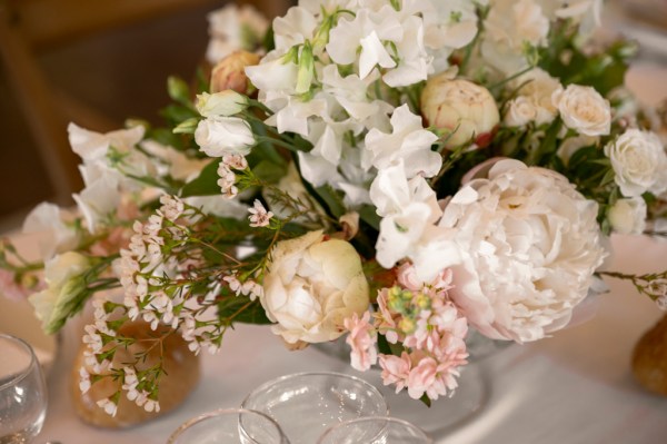 White flowers bouquet on table and glasses