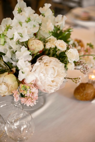 White flowers bouquet on table and glasses