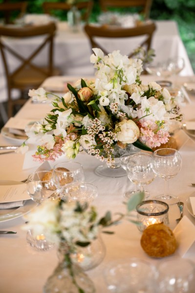 Flowers on the table dining room glasses candles lit roses cutlery