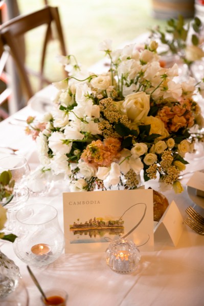 Flowers on the table dining room glasses candles lit roses cutlery