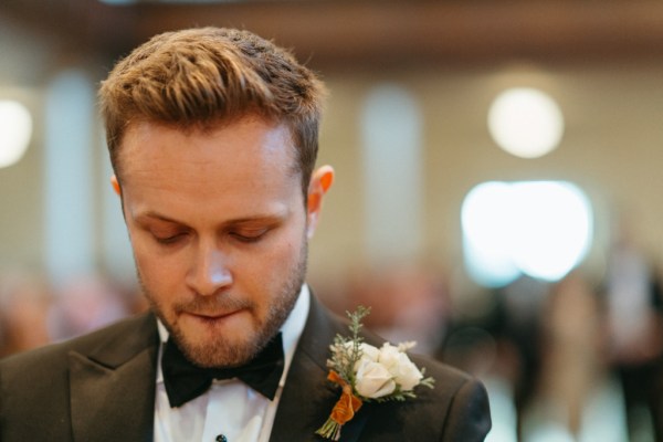 Groom stands at the alter nervously awaiting bride