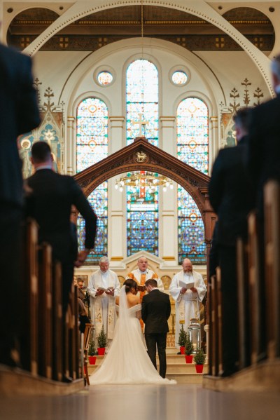 Bride and groom alter to church tinted windows