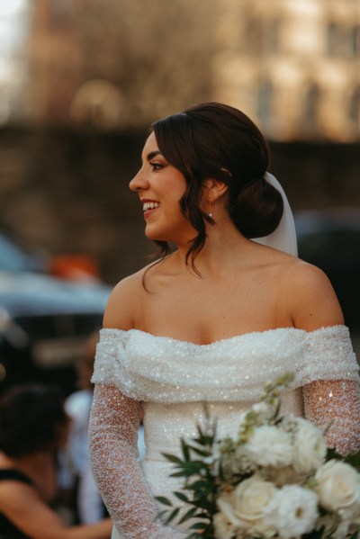 Shot of bride on her own side profile holding bouquet flowers