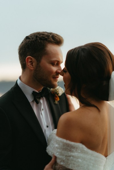 Bride and groom laugh looking at each other