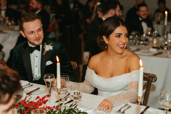 Bride and groom at table candle lighting