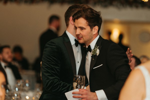 Groom and groomsman hug