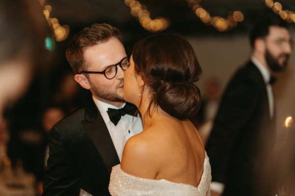 Bride and groom kiss on the dancefloor