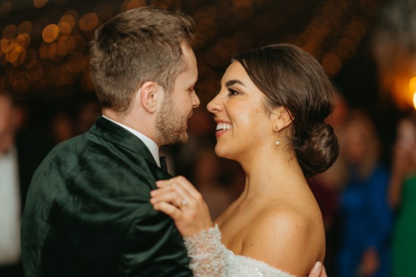 Bride and groom smile looking at each other lovingly