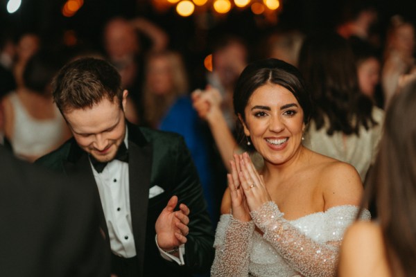 Bride and groom smiling interior dancefloor shot