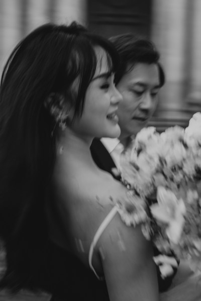 Black and white bride and groom she holds bouquet