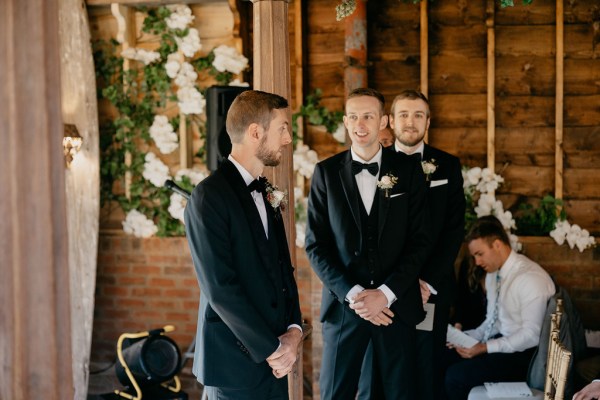 Groom and groomsmen await the bride at the alter