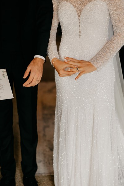 Bride touches her wedding ring hand detail focus of groom