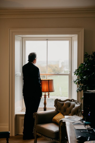 Father looks out the window to garden