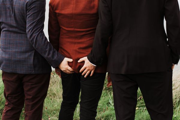 Groomsmen pinch grab grooms bum bottom