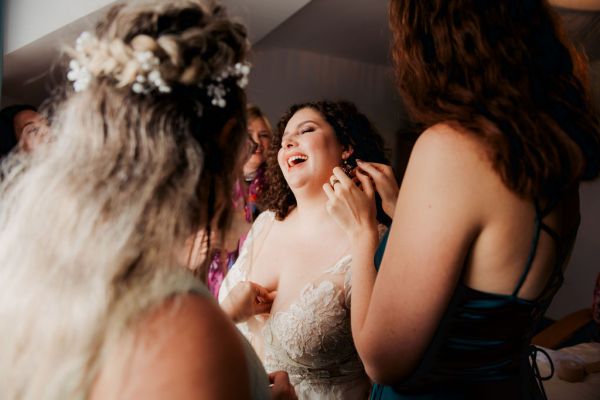 Bride getting her makeup done MUA earrings on