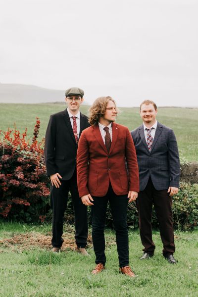 Groom and groomsmen farm mountain grass setting