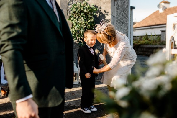 Woman and little boy in black suit tuxedo