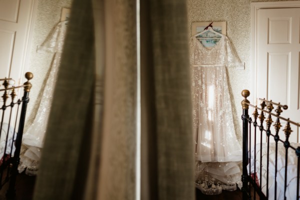 Wedding dress hangs up in room